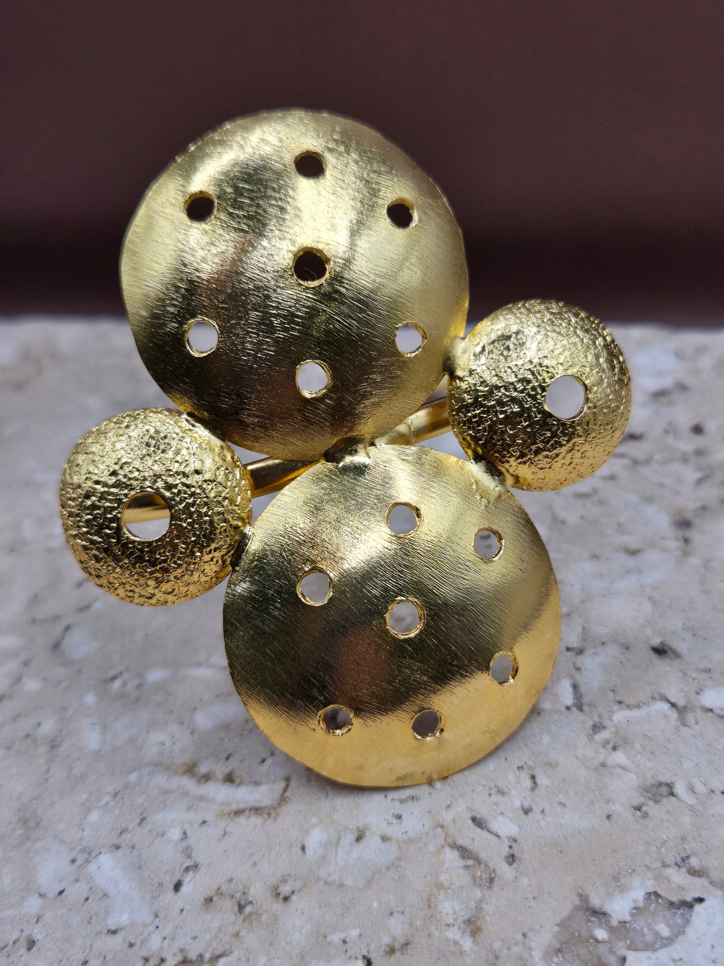 Brazalete círculos perforados, en broce, con baño en oro 24k.